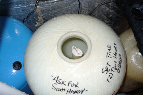 Close-up of a brine tank lid with handwritten service instructions