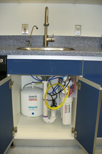 Reverse osmosis storage tank and filters installed under a kitchen sink
