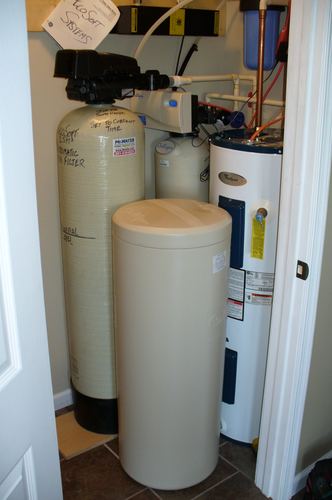 Acid neutralizer, water softener, and water heater installed together