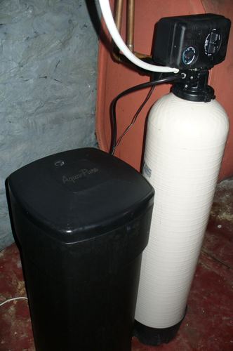 AquaPure water softener and filter tank installed in a basement