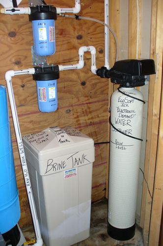 EcoSoft 64K water softener with dual whole-house filters, brine tank, and pressure tank