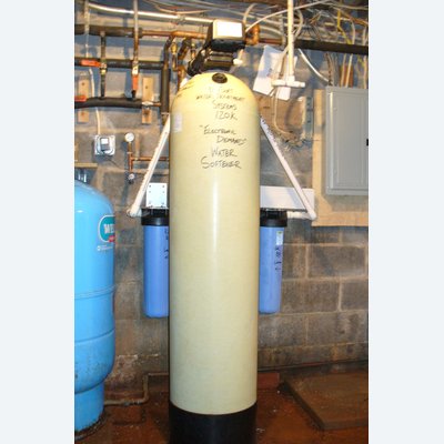 EcoSoft 120K water softener with dual whole-house filters in a commercial setting