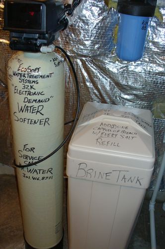 EcoSoft water softener installed near ductwork, labeled to protect from freezing