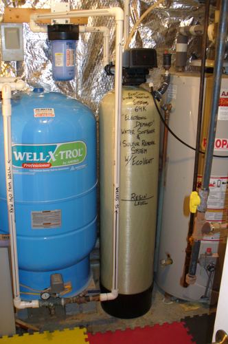 EcoSoft 64K water softener and sulfur removal system with a Well-X-Trol pressure tank and water heater