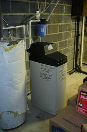 EcoSoft water softener installed next to an older insulated water heater