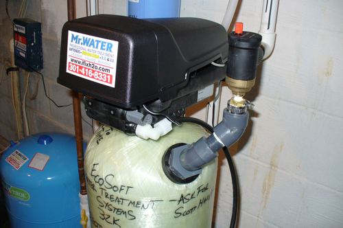 Close-up of a Mr. Water LLC branded control valve on an EcoSoft softener tank