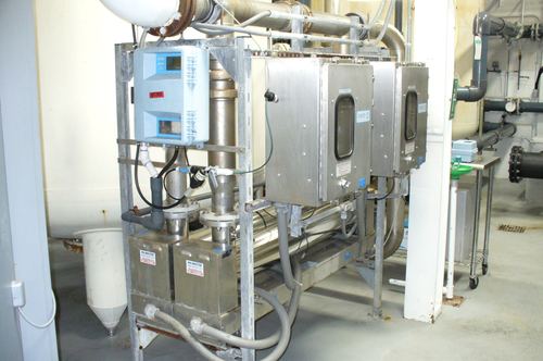 Commercial UV disinfection system with a chlorine analyzer and Mr. Water LLC service labels