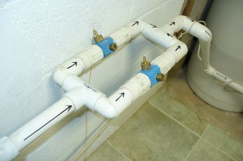 Close-up of plumbing fittings and shutoff valves