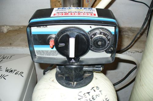 Close-up of a water softener control valve timer