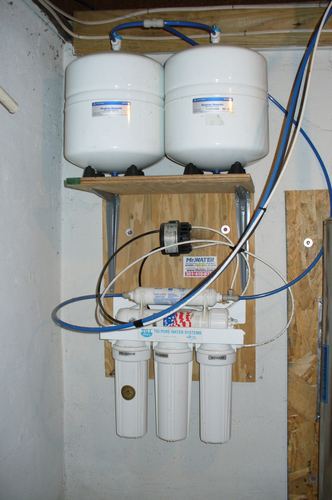 Reverse osmosis storage tanks and a filter system installed on a wall