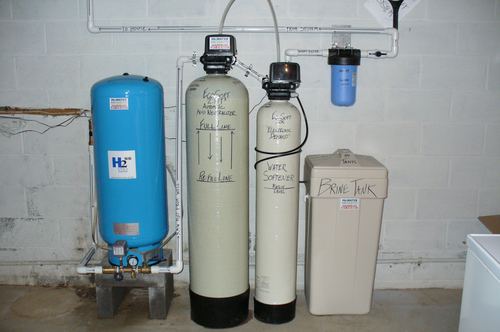 EcoSoft acid neutralizer, water softener, brine tank, and carbon filter installed together