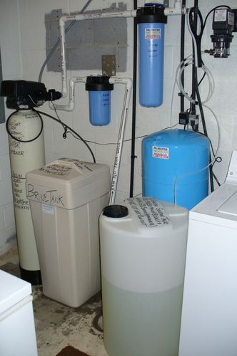 EcoSoft water softener with brine tank, carbon filters, and a solution tank installed together