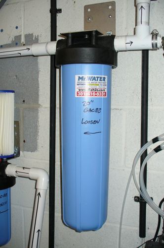 Close-up of a whole-house carbon filter housing