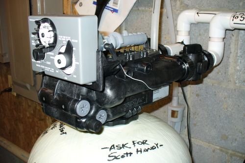 Close-up of a water softener control valve timer