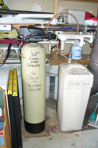 EcoSoft 64K water softener and brine tank installed in a garage