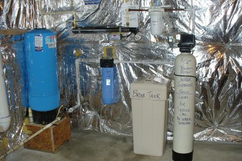 Pressure tank, UV light, whole-house filter, and water softener with brine tank installed together