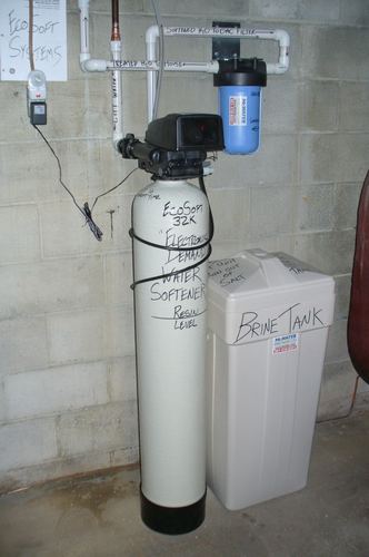 EcoSoft 32K water softener with a brine tank installed in a basement