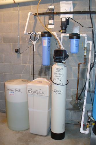 EcoSoft acid neutralizer with a whole-house filter and pressure tank