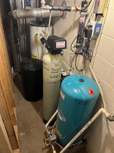 EcoSoft 48K water softener, Well-Rite pressure tank, and water heater installed in a utility closet