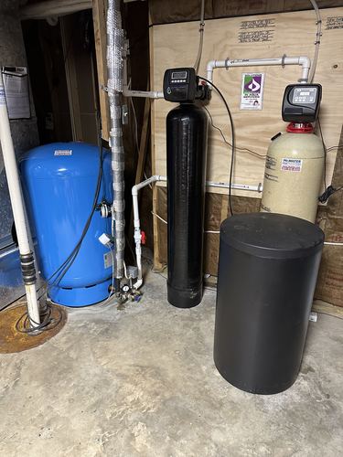 Water softener and acid neutralizer tanks installed in a basement