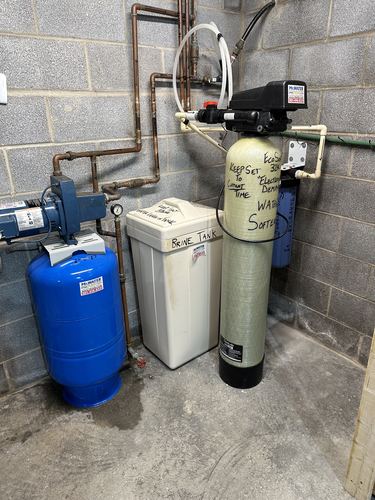 EcoSoft 32K water softener with a brine tank and well pump