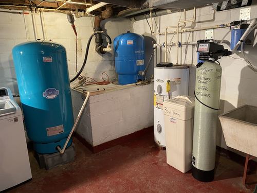 Well pressure tanks, EcoSoft water softener, brine tank, and water heater installed together