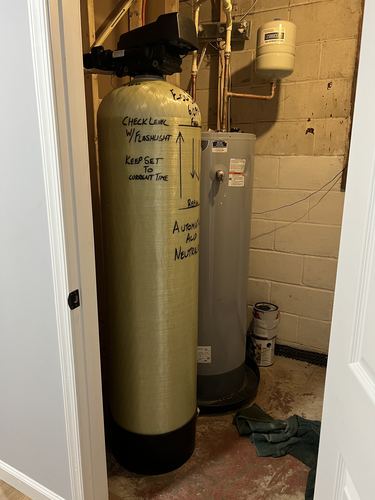 EcoSoft automatic acid neutralizer and water heater installed in a utility closet