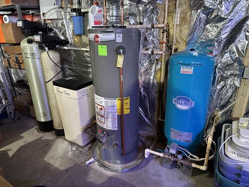 Water softener, brine tank, water heater, and Well-Rite pressure tank installed together