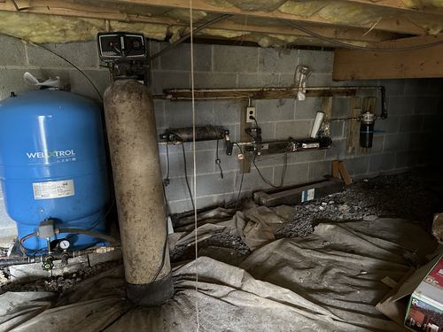 Well-X-Trol pressure tank and water treatment tank installed in a crawlspace