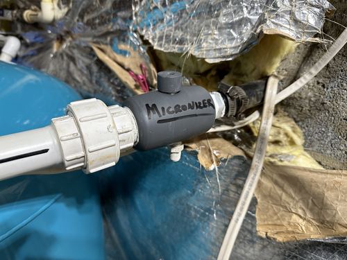 Close-up of a micronizer fitting installed on a water treatment tank