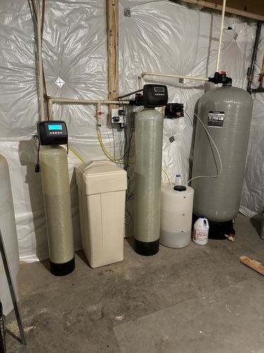 Water softener, brine tank, retention tank, and chemical feed system installed together
