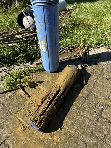 Corroded whole-house filter housing removed during a service call