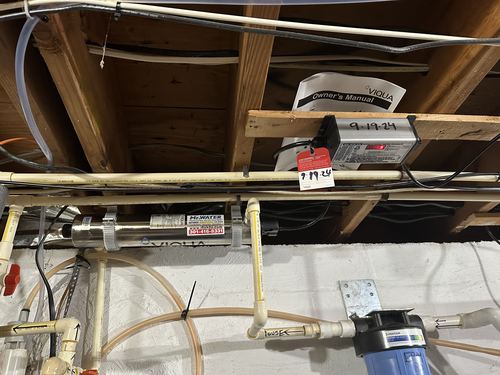 Viqua UV disinfection light system with an electronic controller mounted between ceiling joists
