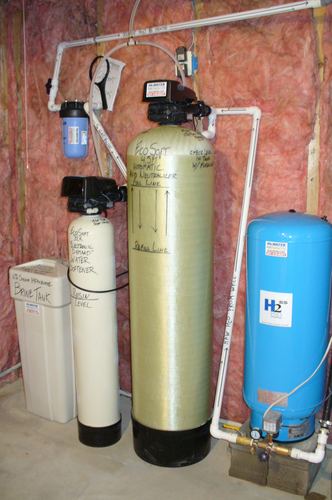EcoSoft acid neutralizer, water softener, brine tank, and pressure tank installed together