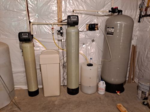 Older water softener, brine tank, and retention tank installed together