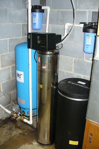 Ionics water softener with dual whole-house filters and a pressure tank