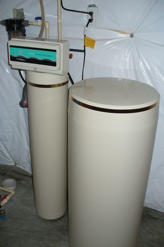 Culligan water softener and brine tank installed in a basement