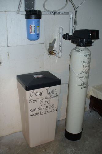 EcoSoft 32K water softener with a brine tank installed in a basement