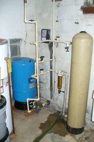 Well pressure tank, inline filter, and water softener installed together