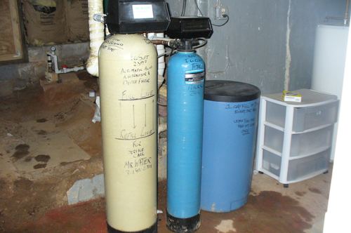 EcoSoft acid neutralizer, iron filter, and brine tank with handwritten service notes