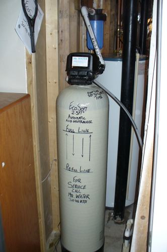 EcoSoft acid neutralizer installed in a closet with a whole-house filter and water heater