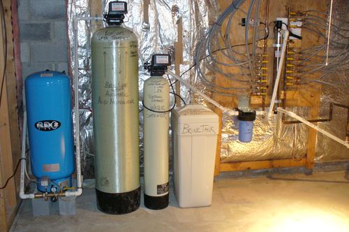 EcoSoft acid neutralizer, water softener, and brine tank with a pressure tank and UV light