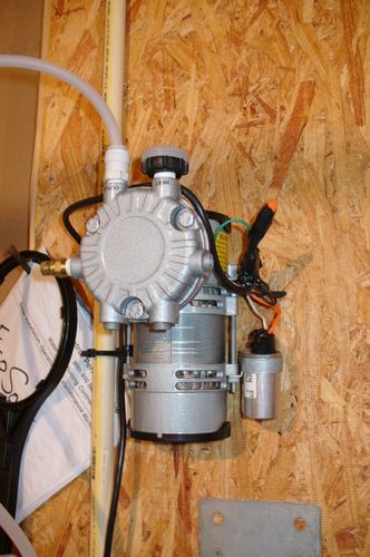 Close-up of an air injector pump motor mounted on a wall