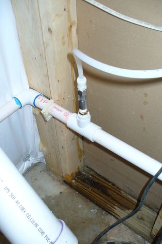 Close-up of a plumbing fitting and shutoff valve