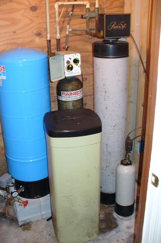 Older RainSoft water softener and filter system with a pressure tank