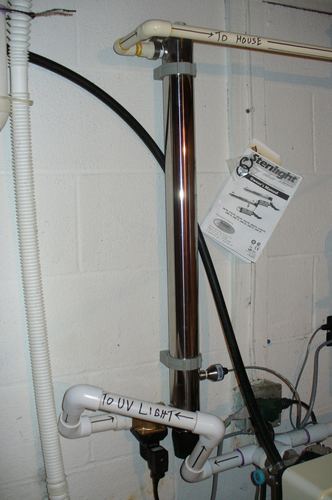 Close-up of a Sterilight UV disinfection light system plumbing connections