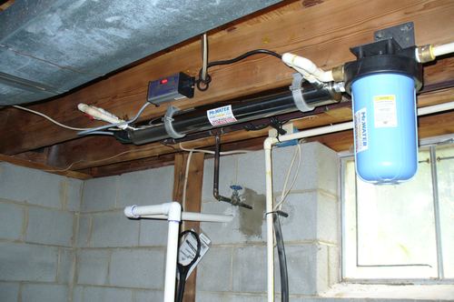 UV disinfection light system with a whole-house filter installed in a basement