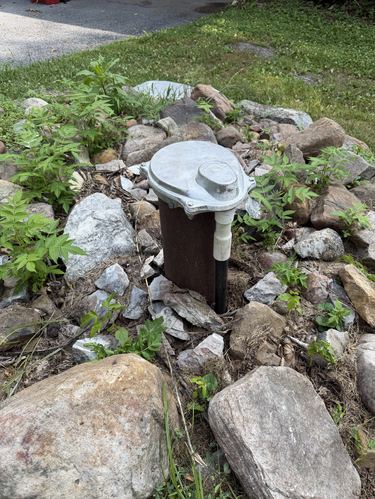 Well casing sanitary seal cap installed outdoors