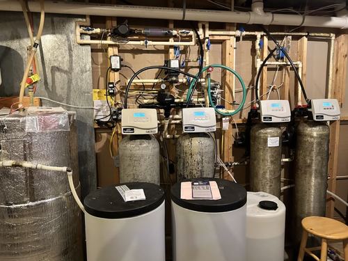 Multiple water softener and filter tanks with digital control valves installed together