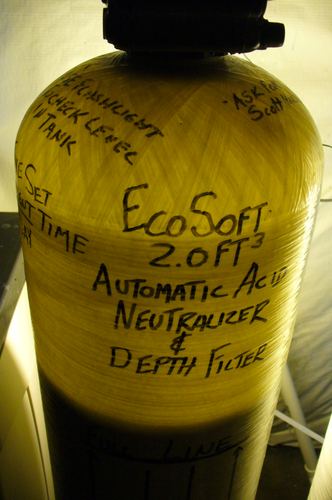 Close-up of an EcoSoft acid neutralizer tank label